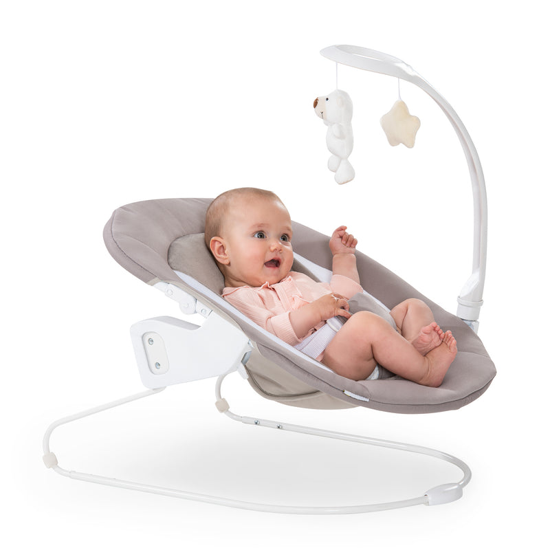 Baby playing with toys on the Sand Hauck Alpha 2in1 Bouncer Deluxe | Baby Swings, Rockers & Baby Bouncers | Toys - Clair de Lune UK
