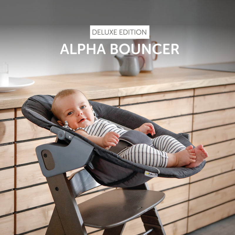 Smiling baby sitting on the Grey Hauck Alpha 2in1 Bouncer Deluxe | Baby Swings, Rockers & Baby Bouncers | Toys - Clair de Lune UK