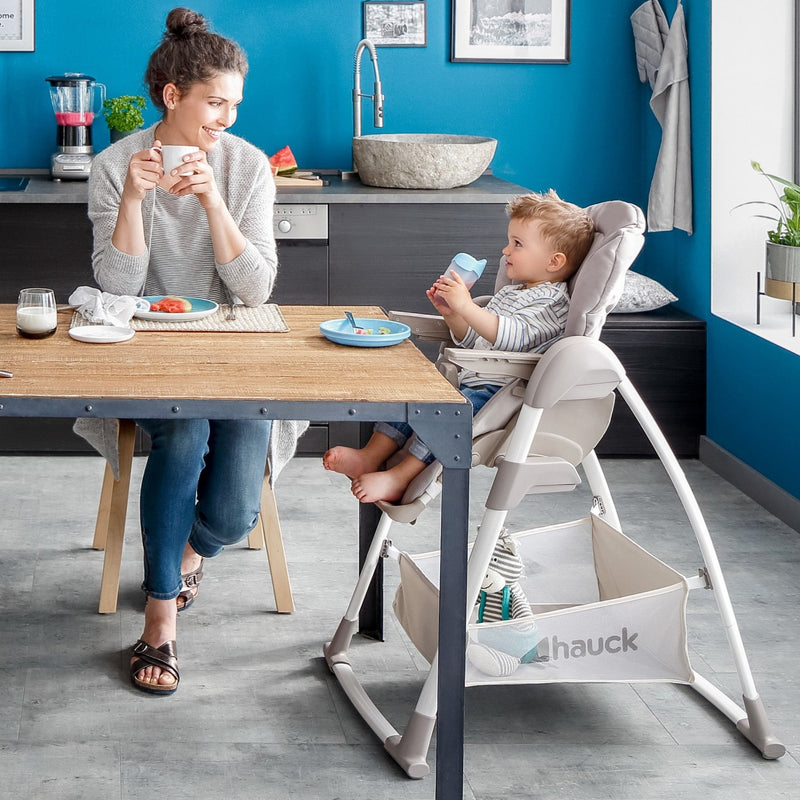 Mum looking at her toddler having his lunch on the Stretch Grey Hauck Travel 3in1 Sit N Relax High Chair & Bouncer | Highchairs | Feeding & Weaning - Clair de Lune UK