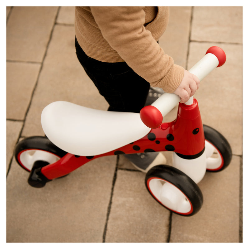Toddler riding the Hauck Ladybug Red 1st Ride Three Balance Bike | Toddler Bikes | Montessori Activities For Babies & Kids - Clair de Lune UK