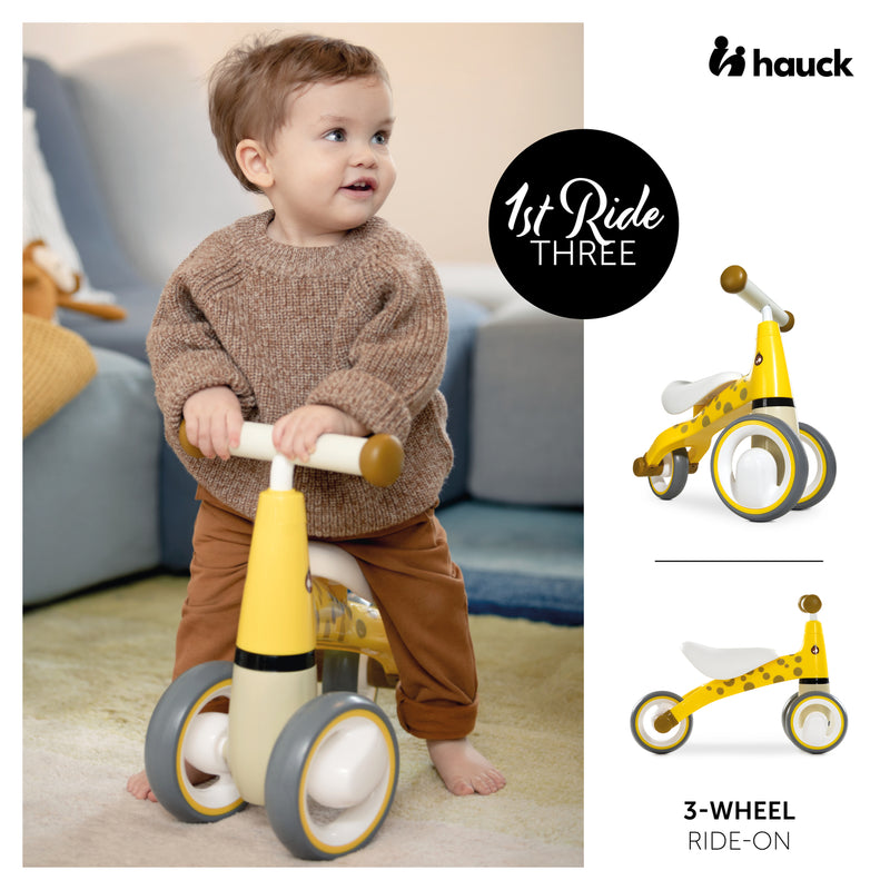 Toddler enjoys riding the Giraffe Yellow Hauck 1st Ride Three Balance Bike | Toddler Bikes | Montessori Activities For Babies & Kids - Clair de Lune UK