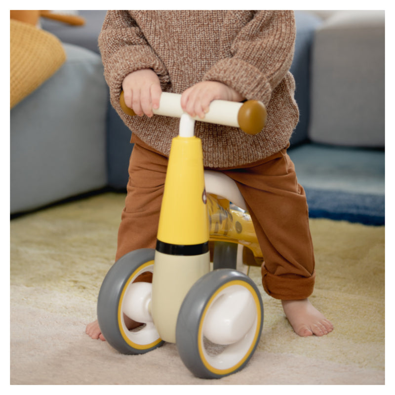 Toddler riding the Giraffe Yellow Hauck 1st Ride Three Balance Bike | Toddler Bikes | Montessori Activities For Babies & Kids - Clair de Lune UK
