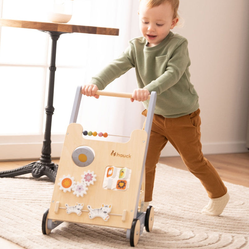 Toddler pushing the Hauck Learn to Walk Montessori Baby Walker | Baby Walkers and Ride On Toys | Montessori Activities For Babies & Kids | Toys | Baby Shower, Birthday & Christmas Gifts - Clair de Lune UK