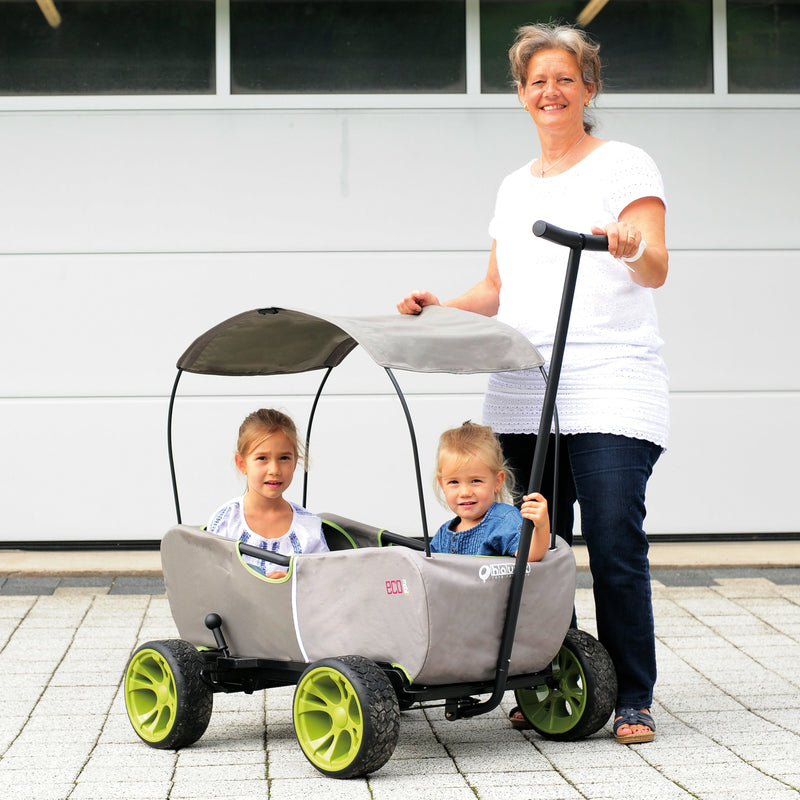 Grandma next to a Hauck Eco Mobil Wagon | Wagons & Go Karts | Baby & Kid Travel - Clair de Lune UK