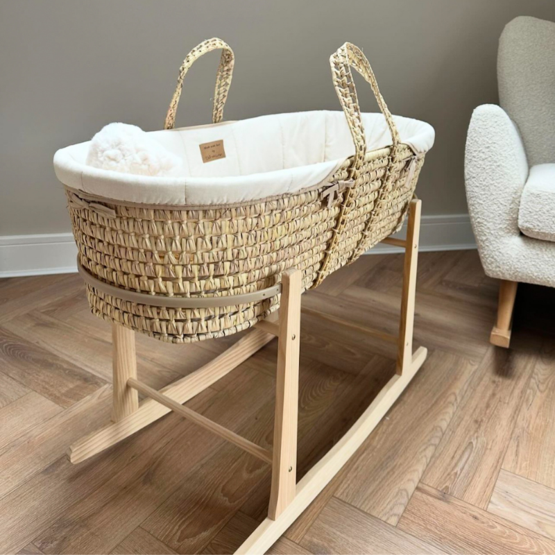 Cream Organic Palm Moses Basket on herringbone Oak floor next to the Rocking Boucle nursing chair in the nursery | Moses Baby Baskets, Bassinets | Nursery Furniture - Clair de Lune UK