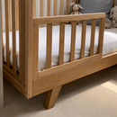 Close up of Oak Cot Bed Extension Kit converted to a toddler bed in neutral nursery | Cots, Cot Beds, Toddler & Kid Beds | Baby Bed| Nursery Furniture - Clair de Lune UK