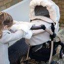 Feather Roma Egg® Dolls Pram Fur Hood and Double Hand Muff showcasing kid pushing the Egg doll pram and enjoying the snuggly kid double hand muff | Toys | Birthday & Christmas Gifts - Clair de Lune UK