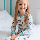 Girl sat in bed wearing the Grow Grows Organic Arctic Animals Pyjamas | Organic Kids PJs and Nightwear - Clair de Lune UK