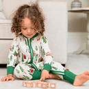 Toddler wearing the Grow Grows Organic Alpine Adventures Sleepsuit playing with toys | Baby Sleepsuits and Baby Grows | Organic Baby Clothing - Clair de Lune UK