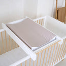 Brown Gingham Anti-Roll Wedge Baby Changing Mat on a cot top changer in the nursery | Baby Bath Time Essentials - Clair de Lune UK