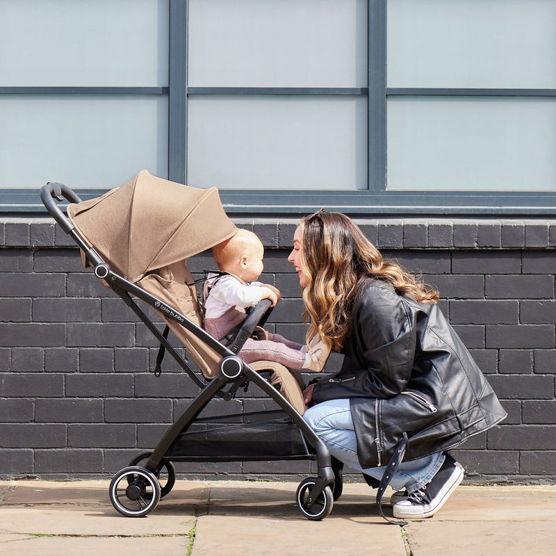 Mum playing with her baby sitting in the Ickle Bubba Aries Max Auto-fold Stroller in Biscuit | Pushchairs and Travel Systems | Baby & Kid Travel - Clair de Lune UK