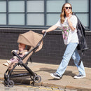 Mum pushing her Ickle Bubba Aries Max Auto-fold Stroller in Biscuit | Prams, Pushchairs & Travel Systems | Baby Travel Essentials - Clair de Lune UK