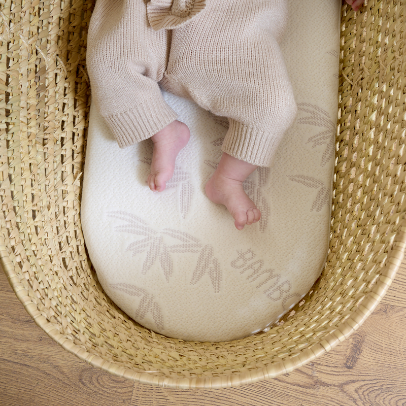 Hypoallergenic and supportive bamboo mattress in the Organic Palm Moses Basket showing little newborn toes | Moses Baby Baskets, Bassinets | Sustainable Baby Essentials | Nursery Furniture - Clair de Lune UK