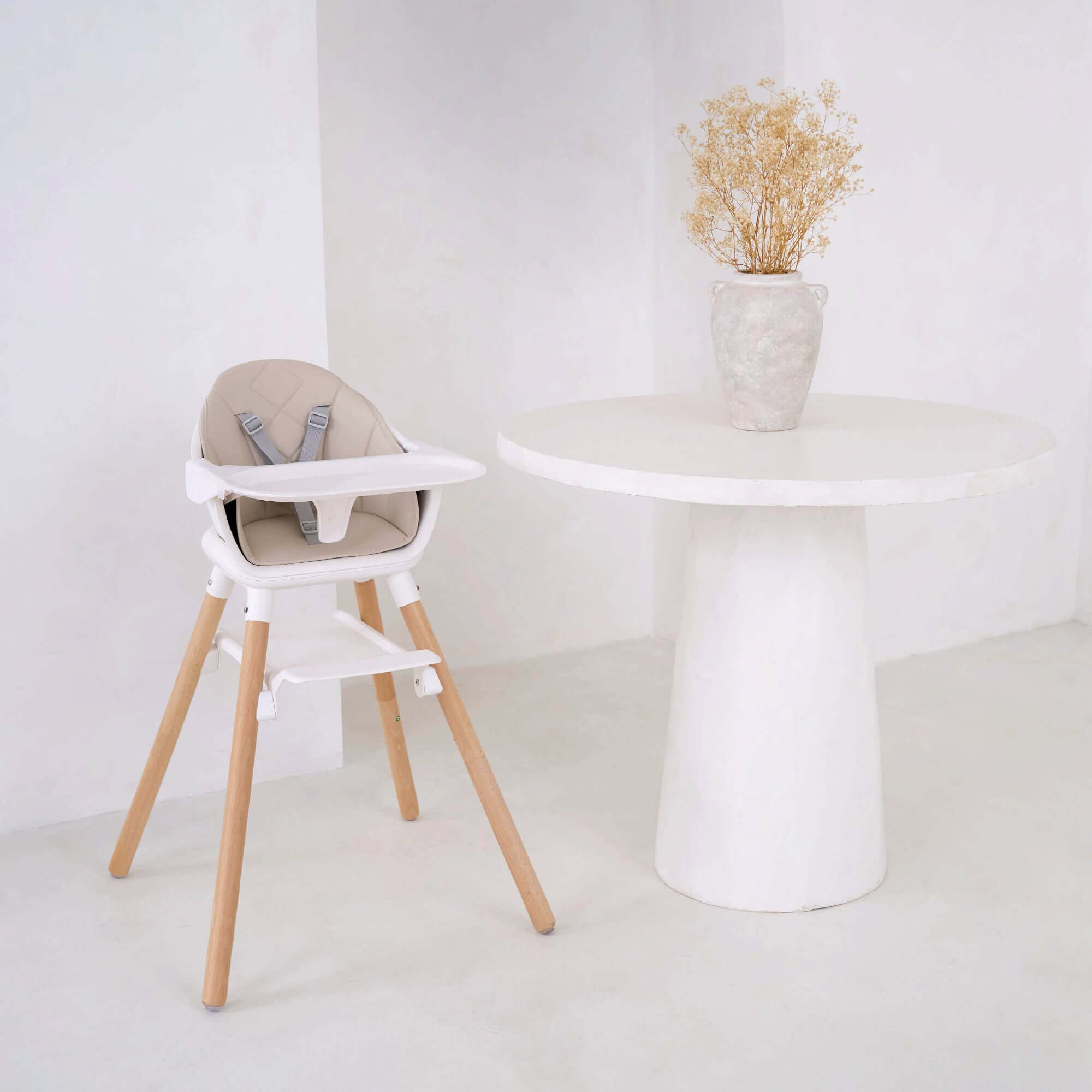 Beige 6 in 1 High Chair in an ultra stylish white home next to a white dining table with textured vase with dry flowers | High chairs | Feeding & Weaning | Toddler Furniture - Clair de Lune UK