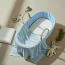 Blue Fleece Palm Moses Basket Bundle including cellular shawl and mattress on a stylish flat lay | Moses Baby Baskets and Bassinets - Clair de Lune UK