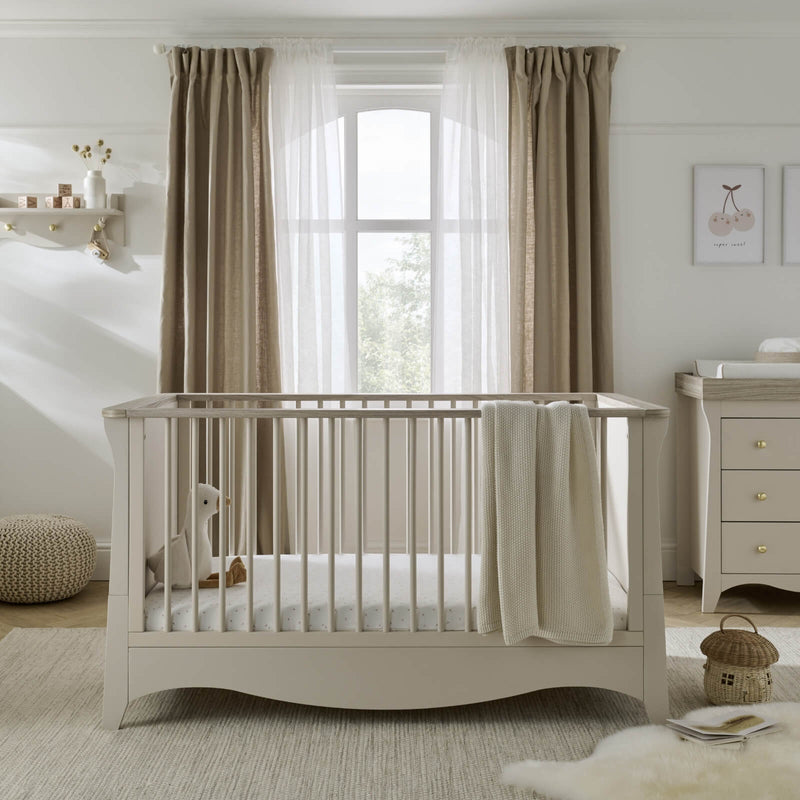 The cot bed of the Cashmere CuddleCo Clara 3pc Nursery Set - 3 Drawer Dresser/Changer, Cot Bed & Wardrobe in a natural Scandi Cream gender-neutral nursery | Nursery Furniture Sets | Room Sets | Nursery Furniture - Clair de Lune UK