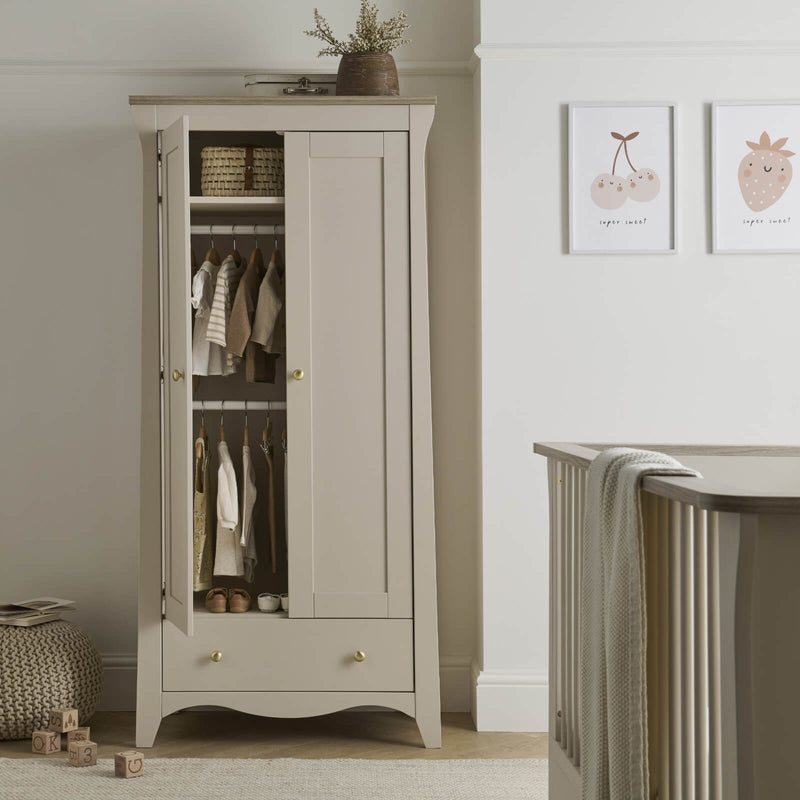  The double wardrobe of the Cashmere CuddleCo Clara 3pc Nursery Set - 3 Drawer Dresser/Changer, Cot Bed & Wardrobe with a door opened in a natural Scandi Cream gender-neutral nursery | Nursery Furniture Sets | Room Sets | Nursery Furniture - Clair de Lune
