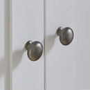 Close up of the satin handles on the White CuddleCo Clara 3 Piece Nursery Furniture Set in a cosy neutral nursery | Nursery Furniture | Cot Bed - Clair de Lune UK