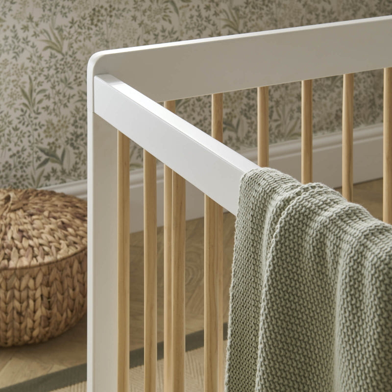 The white and natural materials of the cot bed from the 2-piece room set of the Cuddleco Nola Scandi Cot Bed & Room Sets | Nursery Furniture Sets | Room Sets | Nursery Furniture - Clair de Lune UK