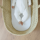 Baby lying on the Moses Basket Mattress Protector in a White Onesie | Soft Baby Sheets | Cot, Cot Bed, Pram, Crib & Moses Basket Bedding - Clair de Lune UK