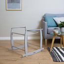 Deluxe Grey Moses Basket Rocking Stand next to a sofa in the living room | Moses Basket Stand | Moses Baby Baskets & Bassinet Accessories | Nursery Furniture - Clair de Lune UK