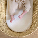 Baby lying on a Quilted Hypoallergenic Moses Basket Mattress in a Palm Mose Basket | Moses Basket Accessories | Nursery Furniture - Clair de Lune UK