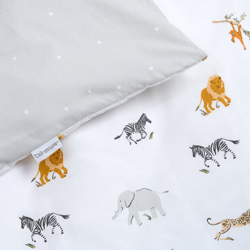 The polka dot and animal prints of the Reversible Jungle Dream Cot Bed Duvet and Pillowcase Set | Bedding - Clair de Lune UK