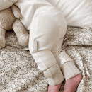 Close up of toddler wearing the Cashmere Grow Grows Organic Pinstripe Sleepsuit | Baby Grows and Onesies | Organic Baby Clothes - Clair de Lune UK