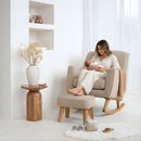 Mum cradling her newborn baby in the Cream Bouclé Rocking Chair with Footstool by a large window and play mat in a white nursery | Nursing Chair | Nursery Furniture - Clair de Lune UK