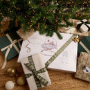 Counting Sheep Baby Bouncer under the Christmas tree wrapped up with beautiful ribbon |  Baby's First Christmas Gift | Baby Toys & Nursery Furniture - Clair de Lune UK