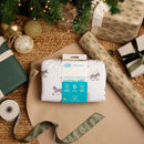 Jungle Dream Sleeping Bag 0-6 months in packaging being unwrapped under the Christmas tree surrounded by gifts and presents | Baby Sleeping Bags and Sleep Sacks | Nursery Bedding | First Christmas Gifts - Clair de  Lune UK