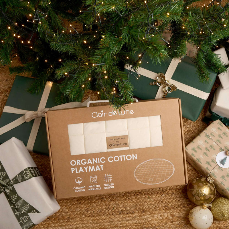 Organic Baby Play Mat in beautiful brown box packaging sitting under the Christmas tree surrounded by beautifully wrapped gifts | Baby Play Mats & Gyms | Baby Tummy Time Toys - Clair de Lune UK