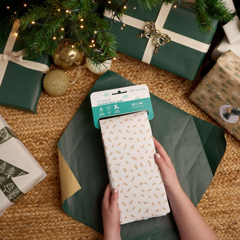 Dash Foldable Travel Changing Mat being unwrapped under the Christmas Tree | Baby's First Christmas | Christmas Gifts for Baby and newborn 2025 - Clair de Lune UK