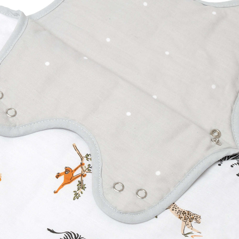 The double poppers on the shoulders of the Jungle Dream Sleeping Bag (0-6 Months) hung on the wall in a Scandi Pastel Green room | Baby Sleep Bags, Shawls, Swaddles & Sleepbags | Nightwear | Nursery - Clair de Lune UK