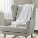Marshmallow Baby Blanket draped over a nursing chair in the nursery | Cosy Baby Blankets | Nursery Bedding - Clair de Lune UK