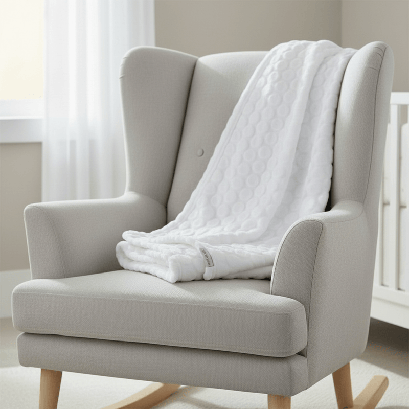 Marshmallow Baby Blanket draped over a nursing chair in the nursery | Cosy Baby Blankets | Nursery Bedding - Clair de Lune UK