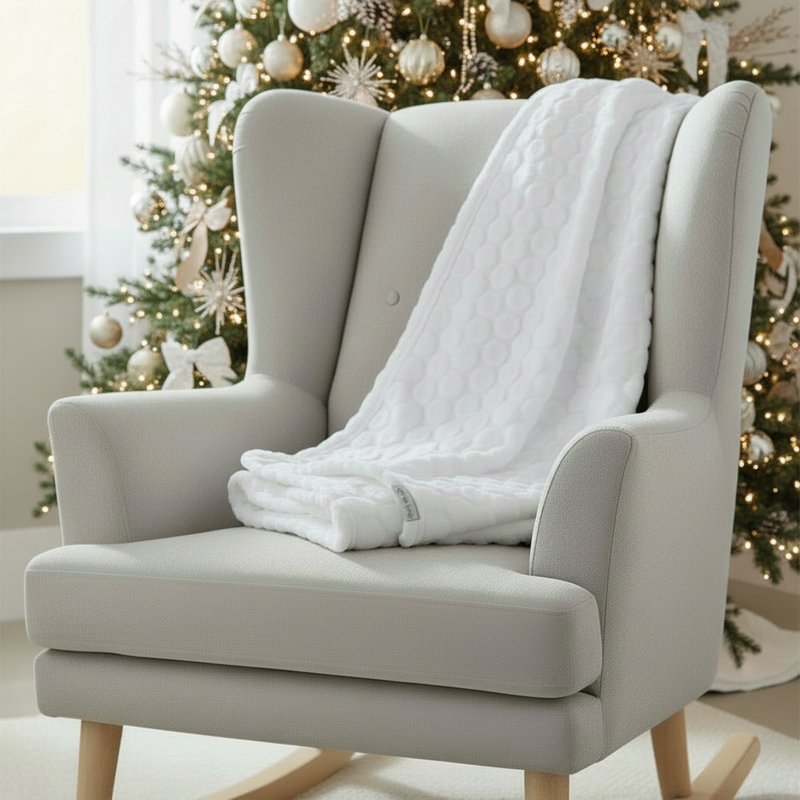 Marshmallow blanket on a rocking chair in front of the christmas tree | Newborn Stocking Fillers | Baby Blankets & Swaddles - Clair de Lune UK