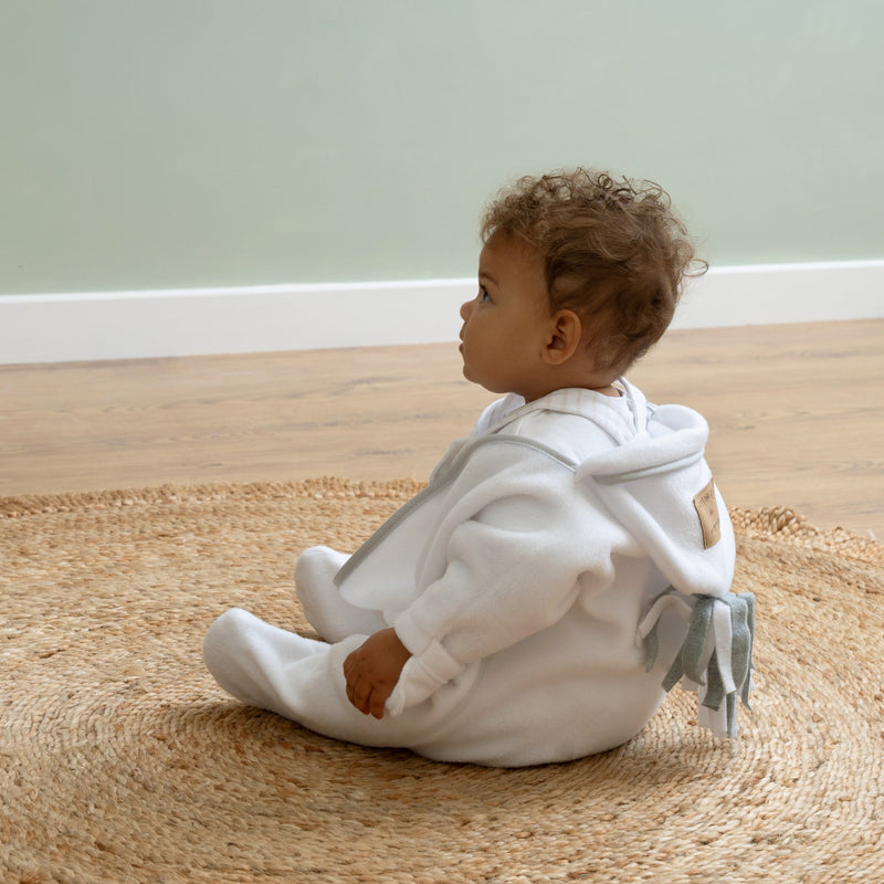 Baby wearing the White Star Fleece Baby Wrap Blanket | Cosy Baby Blankets | Nursery Bedding | Newborn, Baby and Toddler Essentials - Clair de Lune UK