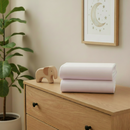 White 2 Pack Universal Fitted Cotton Moses Basket Sheets - 74 x 30 cm folded on a changing unit in the nursery | Soft Baby Sheets | Moses Basket Bedding - Clair de Lune UK