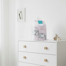 Pink Baby Shower Gift Set in Gift Wrap on a white chest of drawers in a Scandi style nursery | Baby Presents - Clair de Lune UK Sleep Essentials