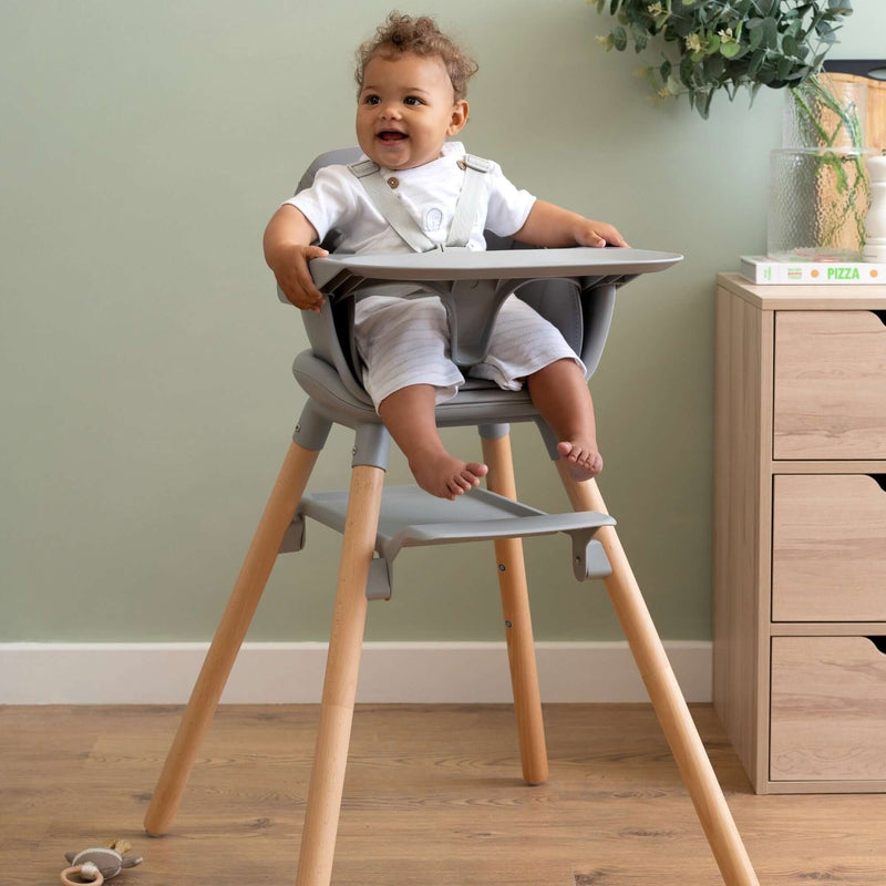 Toddler sitting on the Natural and Grey 6in1 Eat & Play High Chair | Highchairs | Feeding & Weaning - Clair de Lune UK