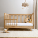 Oak Cot Bed transformed to a toddler bed with the toddler extension in a Scandi Natural Nursery Room | Cots, Cot Beds, Toddler & Kid Beds | Baby Bed | Nursery Furniture - Clair de Lune UK