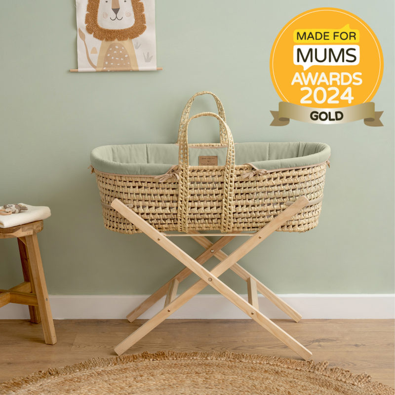 Made for Mums 2024 Award-winning Sage Green Organic Palm Moses Basket on the natural folding stand with the award logo | Moses Baskets and Stands | Co-sleepers | Nursery Furniture - Clair de Lune UK