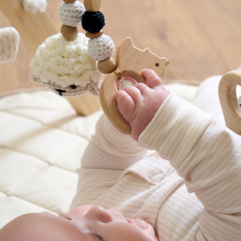 Close up of baby playing with the sheep toy on the Wooden Play Gym | Baby Play Mats & Gyms | Baby Tummy Time Toys - Clair de Lune UK 