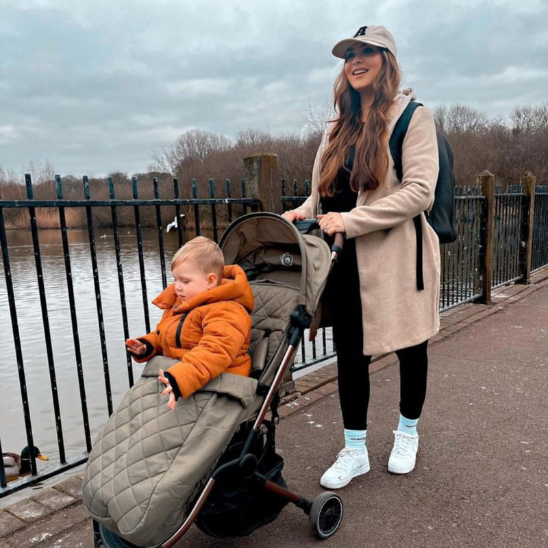 Mum wheeling her kid in the Didofy Green Stargazer 11 Piece Ultimate Travel System Bundle for a sensory walk in a park | Didofy | Pushchairs and Travel Systems | Baby & Kid Travel - Clair de Lune UK