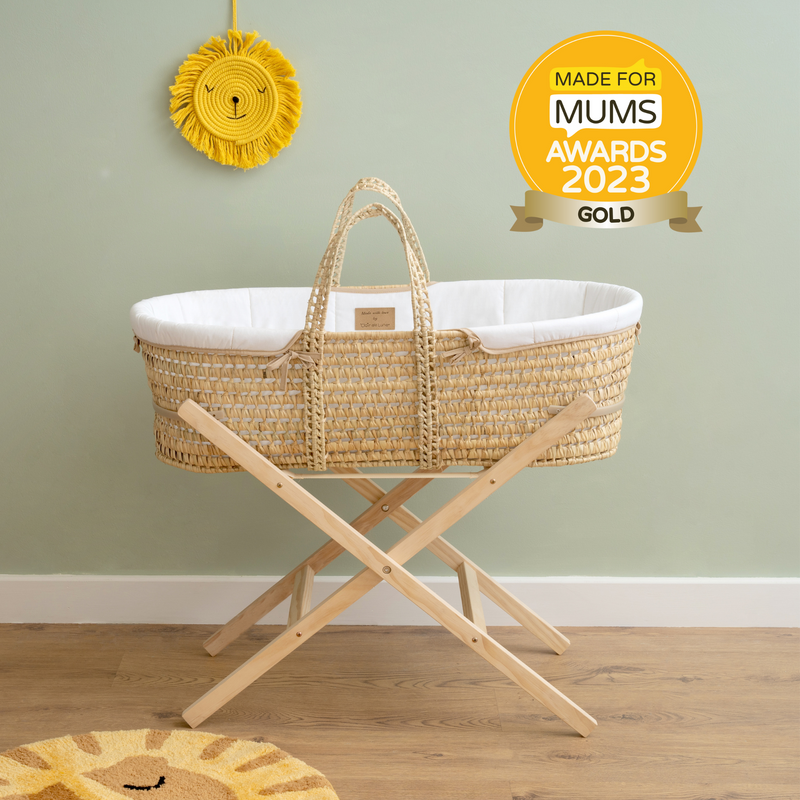 White Organic Palm Moses Basket on the natural folding stand in a sage green nursery | Moses Baskets | Co-sleepers | Nursery Furniture - Clair de Lune UK