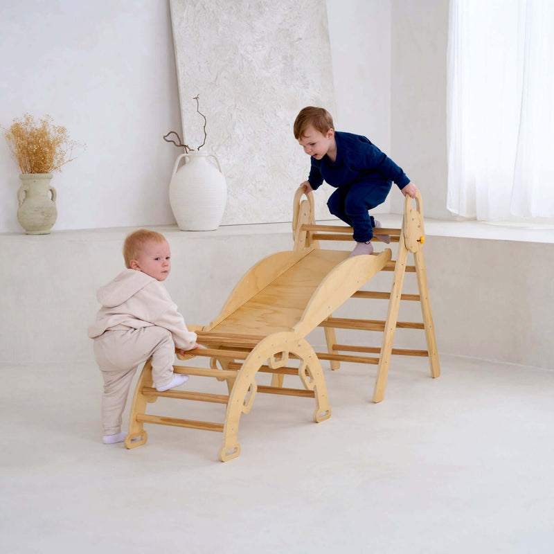Children climbing the rocker and playing on the montessori 3 in 1 wooden activity climbing set in a minimalistic room | Toys | Indoor Play Equipment  | Climbing Frames - Clair de Lune UK