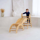 Boy playing climbing the ladders on the 3 in 1 wooden activity climbing set in a minimalistic room | Toys | Indoor Play Equipment  | Climbing Frames - Clair de Lune UK