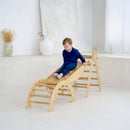 Boy sliding on the montessori 3 in 1 wooden activity climbing set in a minimalistic room | Toys | Indoor Play Equipment  | Climbing Frames - Clair de Lune UK