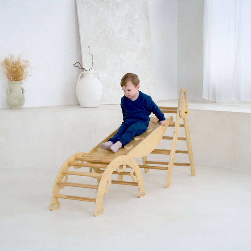Boy sliding on the montessori 3 in 1 wooden activity climbing set in a minimalistic room | Toys | Indoor Play Equipment  | Climbing Frames - Clair de Lune UK
